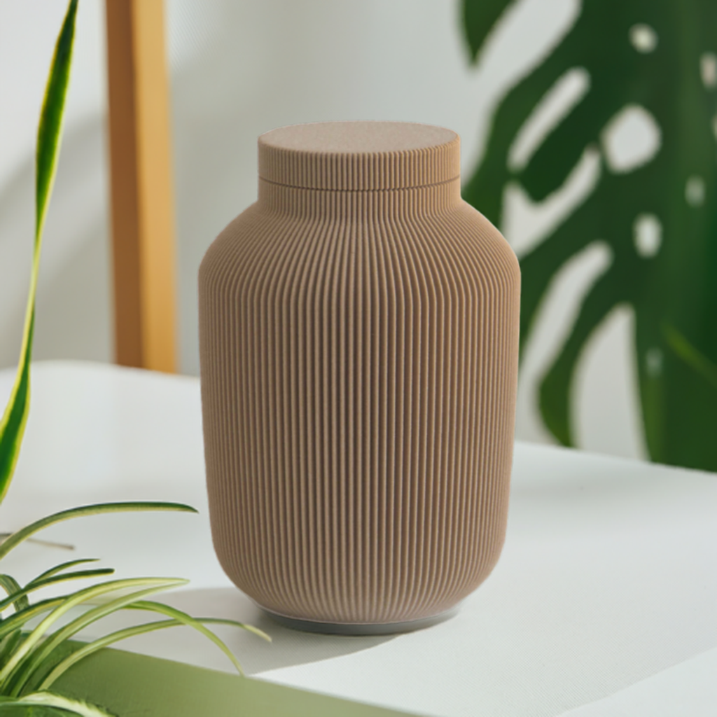 Willow cremation urn in Mocha with modern vertical sculpted texture, displayed with green houseplants.